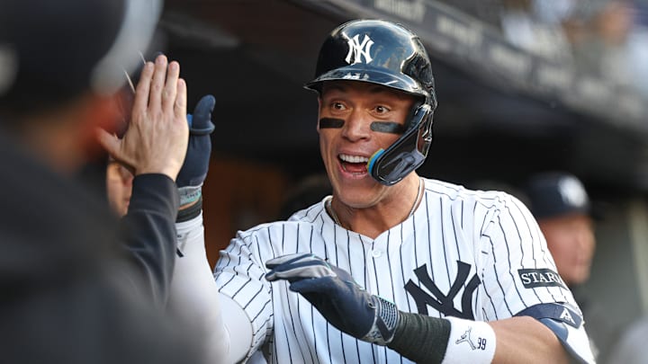 Apr 27, 2025; Bronx, New York, USA;  New York Yankees right fielder Aaron Judge (99) celebrates his solo home run during the sixth inning with teammates against the Toronto Blue Jays at Yankee Stadium. Mandatory Credit: Vincent Carchietta-Imagn Images