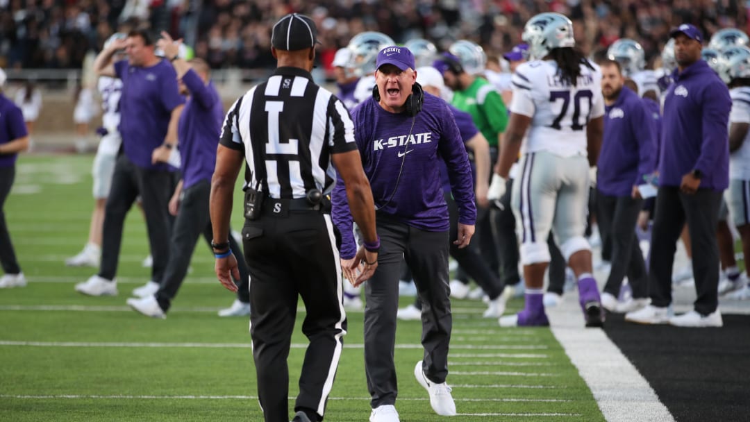 Oct 14, 2023; Lubbock, Texas, USA;  Kansas State Wildcats head coach Chris Klieman argues a call with Big 12 official Quentin Givens in the first half during the game against the Texas Tech Red Raiders at Jones AT&T Stadium and Cody Campbell Field. Mandatory Credit: Michael C. Johnson-USA TODAY Sports