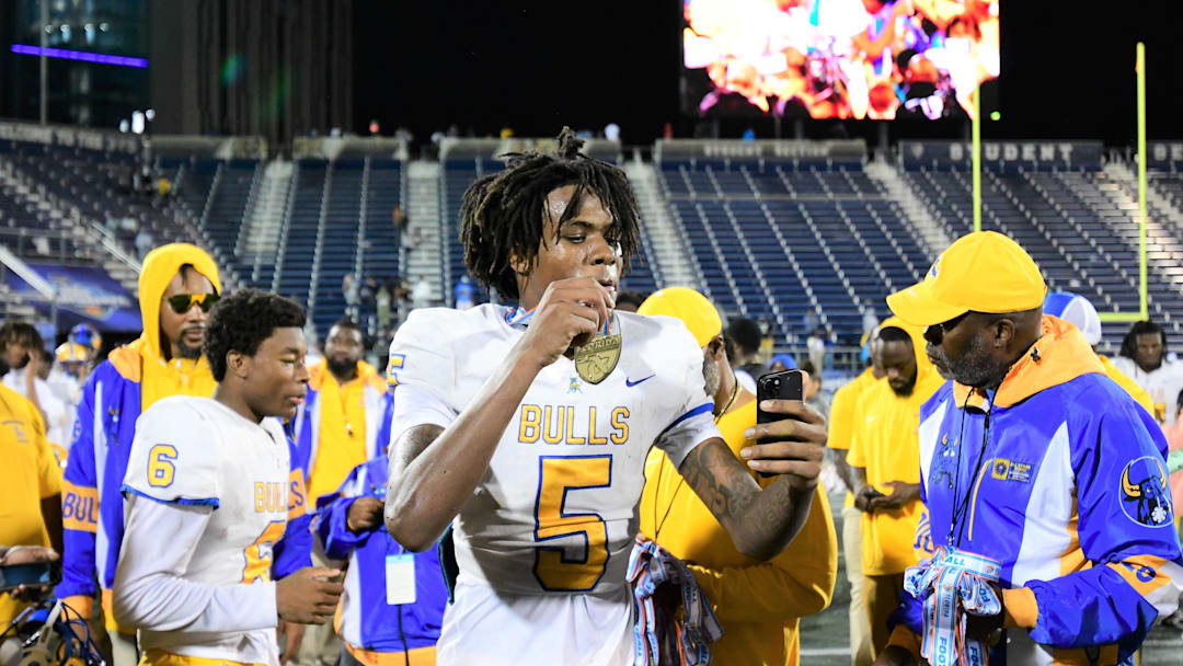 Miami Northwestern's Calvin Russell Jr. takes a selfie with his state medal after his team won the Class 3A championship against Raines on Dec. 14, 2024.
