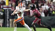 Nov 25, 2023; Columbia, South Carolina, USA; Clemson Tigers quarterback Cade Klubnik (2) gives a stiff arm to South Carolina Gamecocks defensive back Marcellas Dial (6) in the second half at Williams-Brice Stadium. Mandatory Credit: David Yeazell-Imagn Images