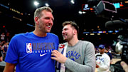 Former Dallas Mavericks guard Luka Doncic (77) greets former player Dirk Nowitzki.