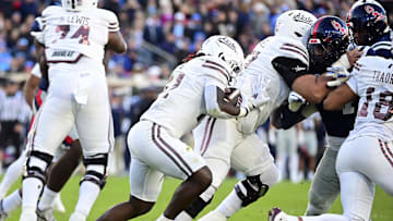 Nov 29, 2024; Oxford, Mississippi, USA; Mississippi State Bulldogs running back Davon Booth (21) runs the ball against the Mississippi Rebels during the second quarter at Vaught-Hemingway Stadium. Mandatory Credit: Matt Bush-Imagn Images