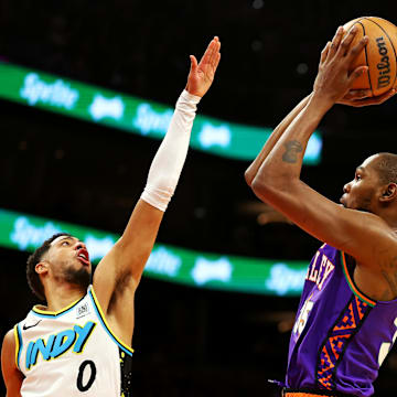 Dec 19, 2024; Phoenix, Arizona, USA; Phoenix Suns forward Kevin Durant (35) shoots the ball against Indiana Pacers guard Tyrese Haliburton (0) during the third quarter at Footprint Center. Mandatory Credit: Mark J. Rebilas-Imagn Images