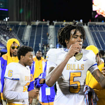 Miami Northwestern's Calvin Russell Jr. takes a selfie with his state medal after his team won the Class 3A championship against Raines on Dec. 14, 2024.