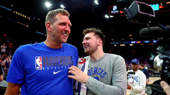 May 15, 2022; Phoenix, Arizona, USA; Dallas Mavericks guard Luka Doncic (77) greets former player Dirk Nowitzki after beating the Phoenix Suns in game seven of the second round for the 2022 NBA playoffs at Footprint Center. Mandatory Credit: Mark J. Rebilas-Imagn Images