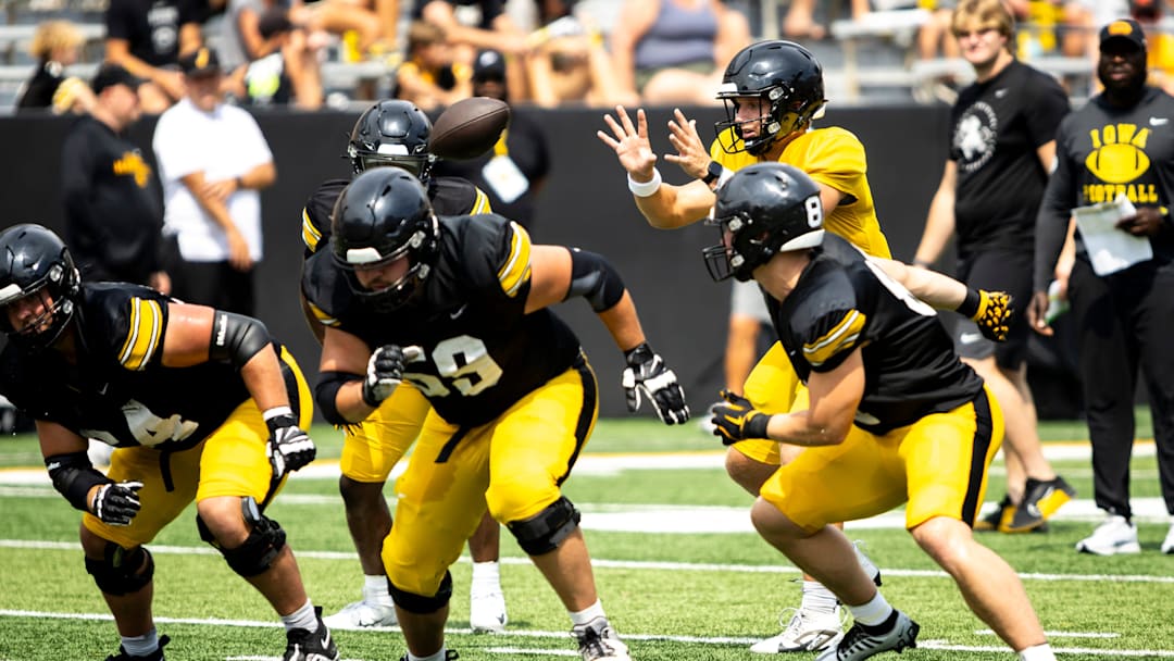 Aug 9, 2025; Iowa quarterback Mark Gronowski (11) catches a snap during the Hawkeyes Kids Day NCAA football open practice at Kinnick Stadium in Iowa City, Iowa. Mandatory Credit: Joseph Cress for the Des Moines Register