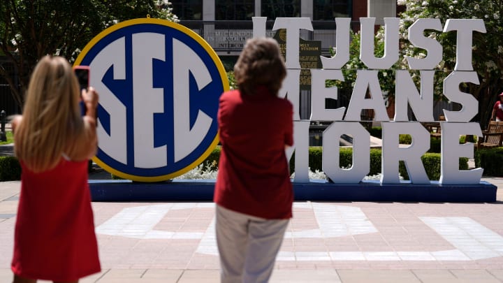 People take photos of an SEC sign outside Gaylord Family-Oklahoma Memorial Stadium in Norman, Okla., during a celebration for OU joining the Southeastern Conference in Norman, Okla., Monday, July 1, 2024.