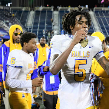 Miami Northwestern's Calvin Russell Jr. takes a selfie with his state medal after his team won the Class 3A championship against Raines on Dec. 14, 2024.