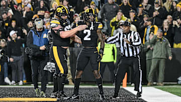 Nov 2, 2024; Iowa City, Iowa, USA; Iowa Hawkeyes offensive lineman Gennings Dunker (67) and running back Kaleb Johnson (2) react after a touchdown run by Johnson against the Wisconsin Badgers during the fourth quarter at Kinnick Stadium. Mandatory Credit: Jeffrey Becker-Imagn Images