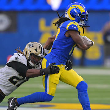 Nov 2, 2025; Inglewood, California, USA; Los Angeles Rams wide receiver Davante Adams (17) runs after the catch as New Orleans Saints safety Justin Reid (21) attempts to make the tackle during the second half at SoFi Stadium. Mandatory Credit: Jayne Kamin-Oncea-Imagn Images