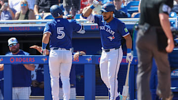 Mar 2, 2025: Toronto Blue Jays outfielder Anthony Santander (25) congratulates outfielder Daulton Varsho (5) after hitting home run against the Philadelphia Phillies in the first inning during spring training at TD Ballpark. 