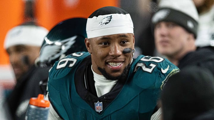 Philadelphia Eagles running back Saquon Barkley stands on the sidelines during a game.