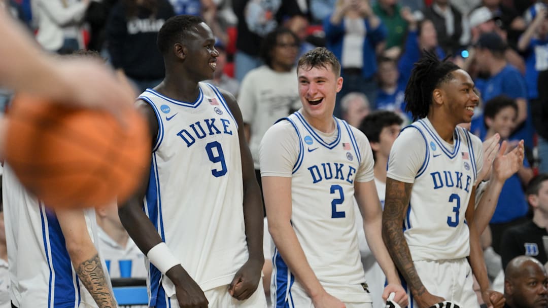Mar 21, 2025; Raleigh, NC, USA; Duke Blue Devils center Khaman Maluach (9), forward Cooper Flagg (2) and guard Isaiah Evans (3) celebrate on the bench during the second half against the Mount St. Mary's Mountaineers in the first round of the NCAA Tournament at Lenovo Center. Mandatory Credit: Zachary Taft-Imagn Images
