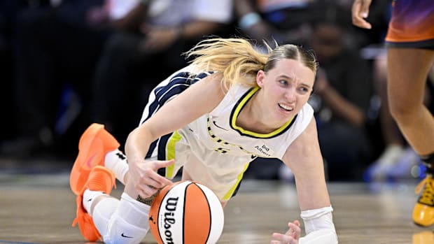 Dallas Wings guard Paige Bueckers falls to the ground after getting fouled by the Phoenix Mercury