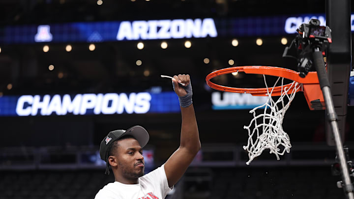 Mar 14, 2026; Kansas City, MO, USA; Arizona Wildcats guard Jaden Bradley (0) cuts the net following a win over the Houston Cougars during the men's Big 12 Conference Tournament Championship at T-Mobile Center. Mandatory Credit: William Purnell-Imagn Images