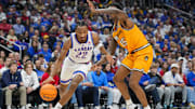 Dec 7, 2025; Kansas City, Missouri, USA; Kansas Jayhawks guard Darryn Peterson (22) drives against Missouri Tigers center Shawn Phillips Jr. (15) during the first half at T-Mobile Center. Mandatory Credit: Jay Biggerstaff-Imagn Images
