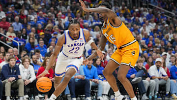 Dec 7, 2025; Kansas City, Missouri, USA; Kansas Jayhawks guard Darryn Peterson (22) drives against Missouri Tigers center Shawn Phillips Jr. (15) during the first half at T-Mobile Center. Mandatory Credit: Jay Biggerstaff-Imagn Images