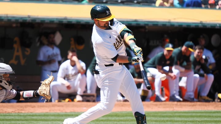 May 23, 2024; Oakland, California, USA; Oakland Athletics first baseman J.D. Davis (5) hits a two-run home run against the Colorado Rockies during the eighth inning at Oakland-Alameda County Coliseum.