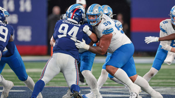 Aug 8, 2024; East Rutherford, New Jersey, USA; Detroit Lions offensive tackle Giovanni Manu (59) blocks New York Giants defensive tackle Elijah Chatman (94) during the second half at MetLife Stadium.  