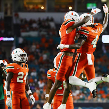 Sep 7, 2024; Miami Gardens, Florida, USA; Miami Hurricanes running back Mark Fletcher Jr. (4) celebrates with running back Jordan Lyle (21) after scoring against the Florida A&M Rattlers during the third quarter at Hard Rock Stadium. Mandatory Credit: Sam Navarro-Imagn Images