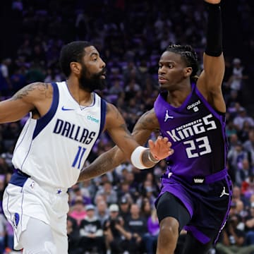 Mar 26, 2024; Sacramento, California, USA; Dallas Mavericks guard Kyrie Irving (11) dribbles the ball against Sacramento Kings guard Keon Ellis (23) during the first quarter at Golden 1 Center. Mandatory Credit: Sergio Estrada-Imagn Images