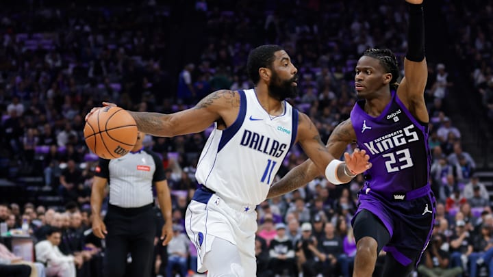 Mar 26, 2024; Sacramento, California, USA; Dallas Mavericks guard Kyrie Irving (11) dribbles the ball against Sacramento Kings guard Keon Ellis (23) during the first quarter at Golden 1 Center. Mandatory Credit: Sergio Estrada-Imagn Images