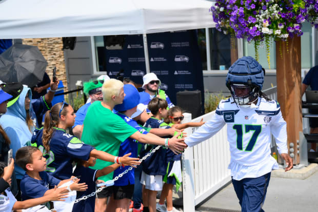 Seattle Seahawks linebacker Jerome Baker (17) interacts with fans before training camp at Virginia Mason Athletic Center.