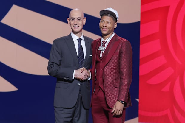 Jeremiah Fears stands with the NBA commissioner Adam Silver