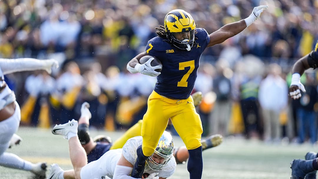 Michigan running back Donovan Edwards (7) runs against Oregon linebacker Bryce Boettcher (28) during the first half at Michigan Stadium in Ann Arbor on Saturday, Nov. 2, 2024.
