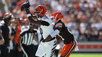 Sep 7, 2025; Cleveland, Ohio, USA; Cincinnati Bengals wide receiver Tee Higgins (5) is pushed out of bounds by Cleveland Browns cornerback Denzel Ward (21) during the second half at Huntington Bank Field. Mandatory Credit: Scott Galvin-Imagn Images
