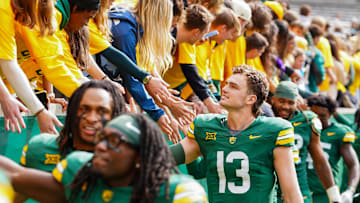 Baylor Bears quarterback Sawyer Robertson (13) high fives the fans in the student section following a game against the UCF Knights at McLane Stadium