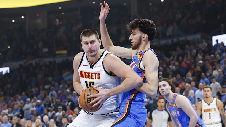 Oct 29, 2023; Oklahoma City, Oklahoma, USA; Denver Nuggets center Nikola Jokic (15) drives to the basket against Oklahoma City Thunder forward Chet Holmgren (7) during the first quarter at Paycom Center. Mandatory Credit: Alonzo Adams-Imagn Images