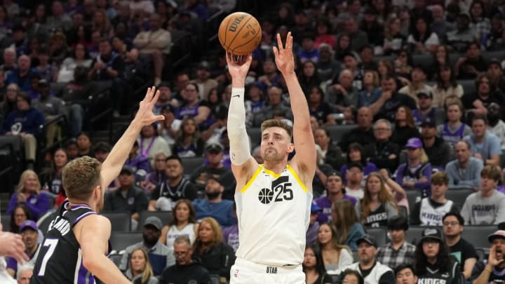 Mar 31, 2024; Sacramento, California, USA; Utah Jazz center Micah Potter (25) shoots against Sacramento Kings forward Sasha Vezenkov (7) during the third quarter at Golden 1 Center. Mandatory Credit: Darren Yamashita-USA TODAY Sports