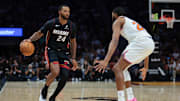 Oct 26, 2025; Miami, Florida, USA; Miami Heat guard Norman Powell (24) dribbles the basketball as New York Knicks guard Mikal Bridges (25) defends during the second quarter at Kaseya Center. Mandatory Credit: Sam Navarro-Imagn Images