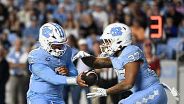 Nov 8, 2025; Chapel Hill, North Carolina, USA; North Carolina Tar Heels quarterback Gio Lopez (7) hands the ball off to running back Davion Gause (37) in the second quarter at Kenan Stadium. Mandatory Credit: Bob Donnan-Imagn Images