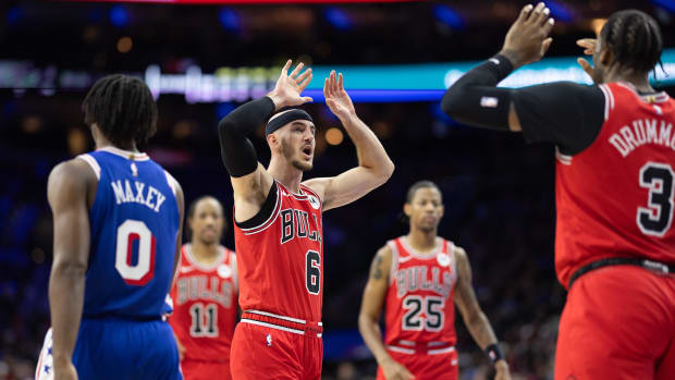 Chicago Bulls guard Alex Caruso reacts with center Andre Drummond 