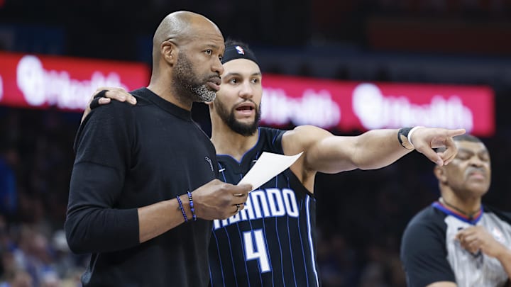 Jan 13, 2024; Oklahoma City, Oklahoma, USA; Orlando Magic guard Jalen Suggs (4) talks to head coach Jamahl Mosley during the second quarter at Paycom Center. Mandatory Credit: Alonzo Adams-Imagn Images Jan 13, 2024; Oklahoma City, Oklahoma, USA; Orlando Magic guard Jalen Suggs (4) talks to head coach Jamahl Mosley during the second quarter at Paycom Center. Mandatory Credit: Alonzo Adams-Imagn Images
