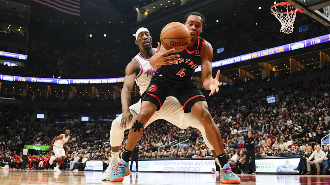 Feb 21, 2025; Toronto, Ontario, CAN; Toronto Raptors forward Scottie Barnes (4) battles for a loose ball against Miami Heat center Bam Adebayo (13) during the first halfat Scotiabank Arena. Mandatory Credit: Kevin Sousa-Imagn Images Feb 21, 2025; Toronto, Ontario, CAN; Toronto Raptors forward Scottie Barnes (4) battles for a loose ball against Miami Heat center Bam Adebayo (13) during the first halfat Scotiabank Arena. Mandatory Credit: Kevin Sousa-Imagn Images