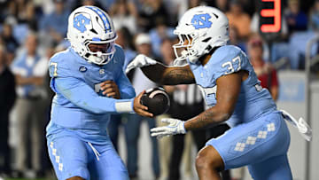 Nov 8, 2025; Chapel Hill, North Carolina, USA; North Carolina Tar Heels quarterback Gio Lopez (7) hands the ball off to running back Davion Gause (37) in the second quarter at Kenan Stadium. Mandatory Credit: Bob Donnan-Imagn Images
