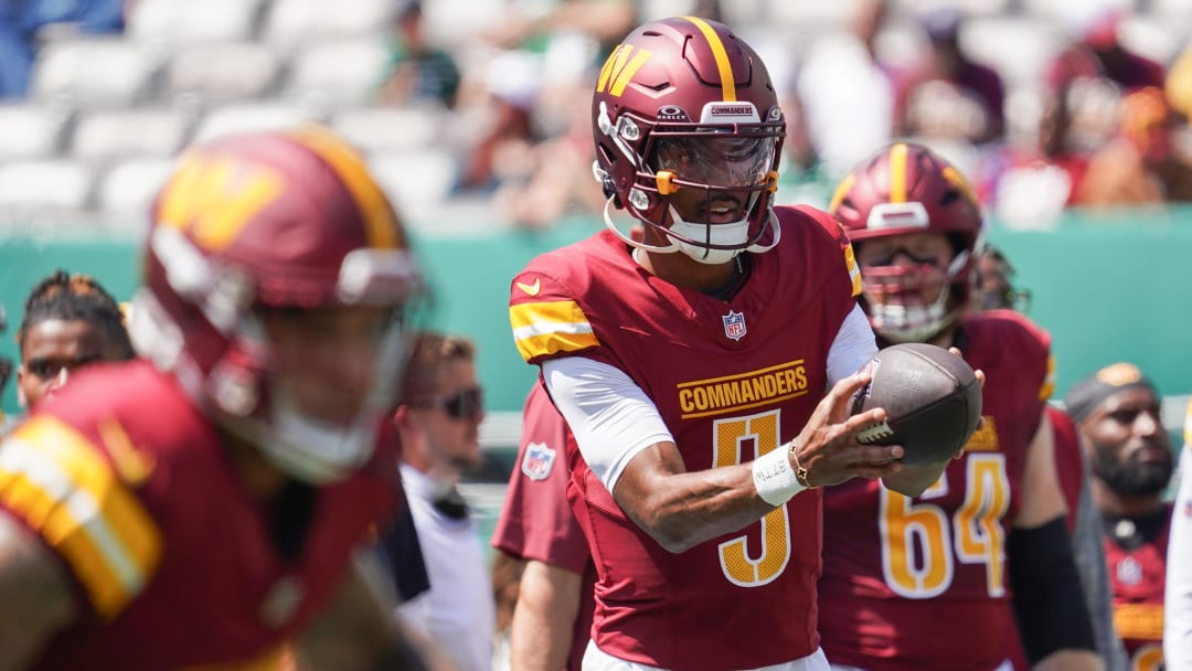 Aug 10, 2024; East Rutherford, New Jersey, USA; Washington Commanders quarterback Jayden Daniels (5) warms up before the game against the New York Jets at MetLife Stadium. Mandatory Credit: Lucas Boland-USA TODAY Sports