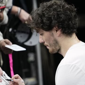 Dec 17, 2023; San Antonio, Texas, USA; San Antonio Spurs forward Cedi Osman (16) signs autographs for fans before a game against the New Orleans Pelicans at Frost Bank Center. Mandatory Credit: Scott Wachter-USA TODAY Sports