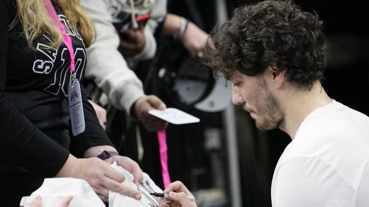 Dec 17, 2023; San Antonio, Texas, USA; San Antonio Spurs forward Cedi Osman (16) signs autographs for fans before a game against the New Orleans Pelicans at Frost Bank Center. Mandatory Credit: Scott Wachter-USA TODAY Sports