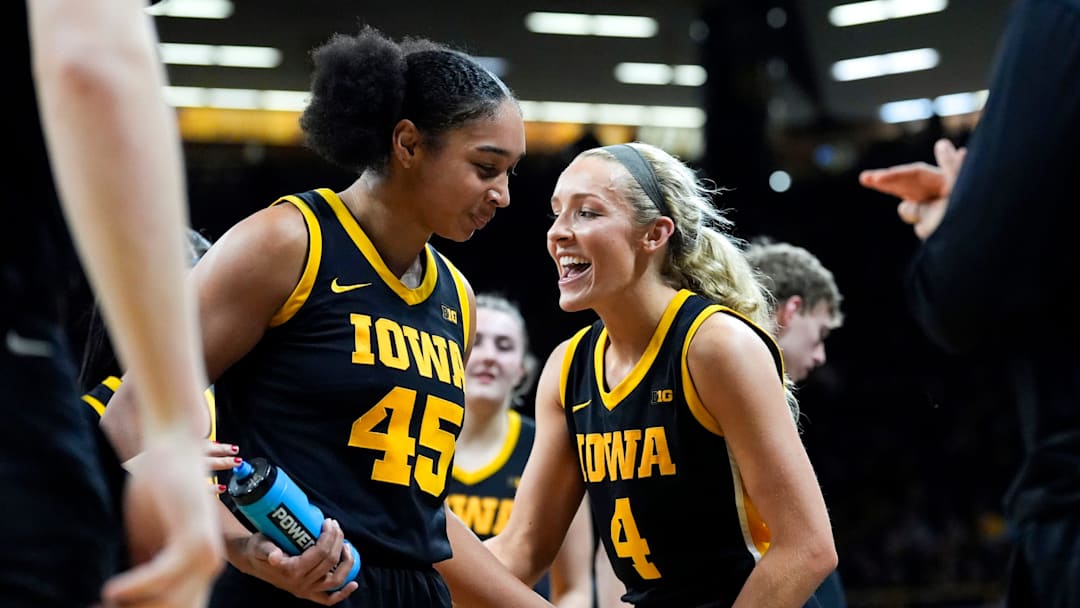 Iowa forward Hannah Stuelke (45) and Iowa guard Kylie Feuerbach (4) during a timeout Jan. 15, 2026 during a basketball game against the Oregon Ducks at Carver-Hawkeye Arena in Iowa City, Iowa.