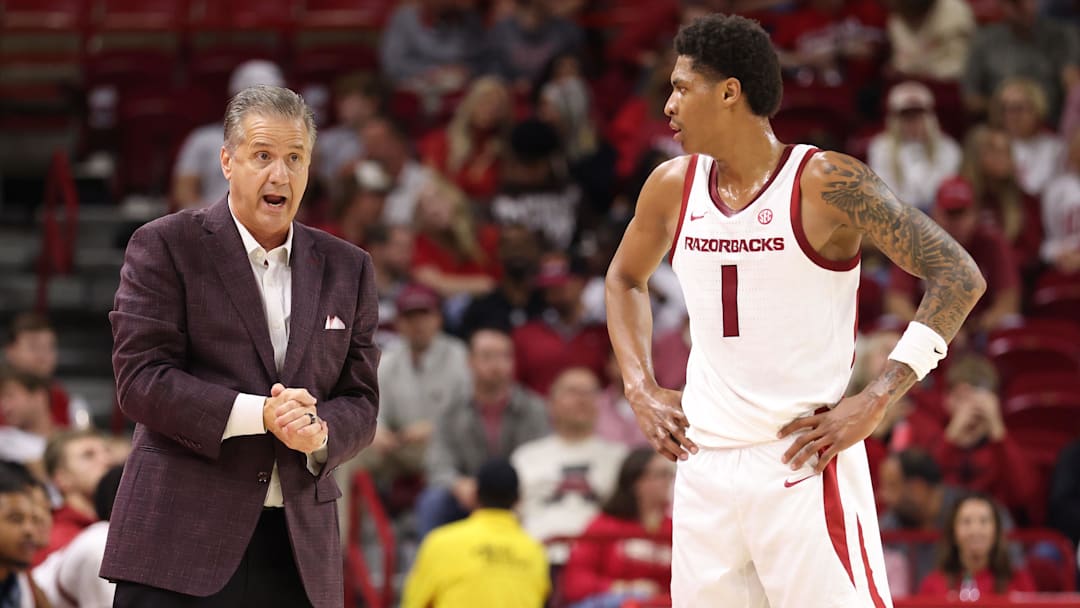 Nov 18, 2025; Fayetteville, Arkansas, USA; Arkansas Razorbacks head coach John Calipari talks to guard Meleek Thomas (1) during the first half against the Winthrop Eagles during the first half at Bud Walton Arena. Mandatory Credit: Nelson Chenault-Imagn Images