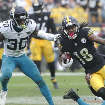 Oct 29, 2023; Pittsburgh, Pennsylvania, USA; Pittsburgh Steelers wide receiver Diontae Johnson (18) runs after a catch as Jacksonville Jaguars safety Rayshawn Jenkins (2)  and cornerback Montaric Brown (30) defend during the third quarter at Acrisure Stadium. Mandatory Credit: Charles LeClaire-USA TODAY Sports