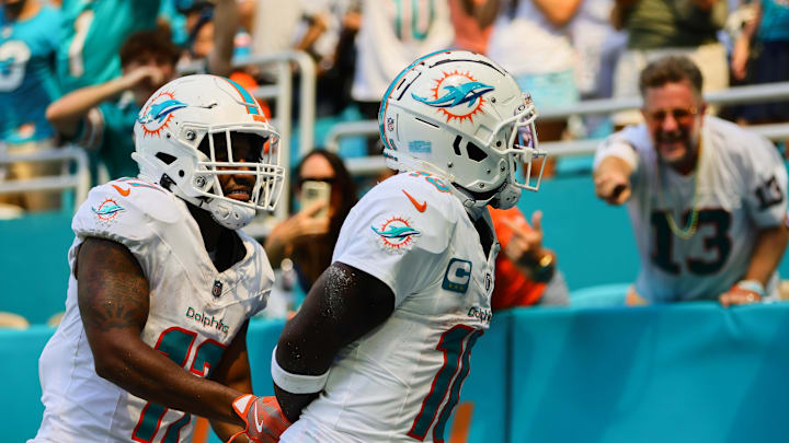 Sep 8, 2024; Miami Gardens, Florida, USA; Miami Dolphins wide receiver Tyreek Hill (10) celebrates with wide receiver Jaylen Waddle (17) after scoring a touchdown against the Jacksonville Jaguars during the third quarter at Hard Rock Stadium. Mandatory Credit: Sam Navarro-Imagn Images