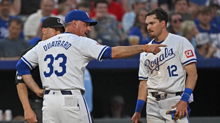 Jun 27, 2024; Kansas City, Missouri, USA;  Kansas City Royals manager Matt Quatraro (33) argues with third base umpire Tripp Gibson (73) about Nick Loftin (12) being called out at third base in the fifth inning against the Cleveland Guardians at Kauffman Stadium. Mandatory Credit: Peter Aiken-USA TODAY Sports