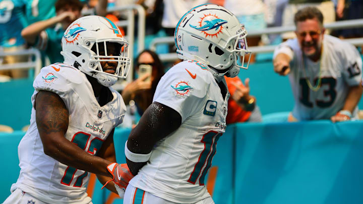 Sep 8, 2024; Miami Gardens, Florida, USA; Miami Dolphins wide receiver Tyreek Hill (10) celebrates with wide receiver Jaylen Waddle (17) after scoring a touchdown against the Jacksonville Jaguars during the third quarter at Hard Rock Stadium. Mandatory Credit: Sam Navarro-Imagn Images