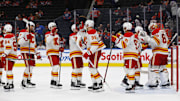 Oct 13, 2024; Edmonton, Alberta, CAN; The Calgary Flames celebrate a 4-1 win over the Edmonton Oilers at Rogers Place. Mandatory Credit: Perry Nelson-Imagn Images