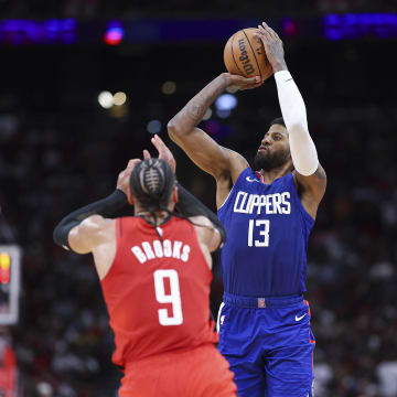 Mar 6, 2024; Houston, Texas, USA; Los Angeles Clippers forward Paul George (13) shoots the ball as Houston Rockets forward Dillon Brooks (9) defends during the fourth quarter at Toyota Center. Mandatory Credit: Troy Taormina-USA TODAY Sports